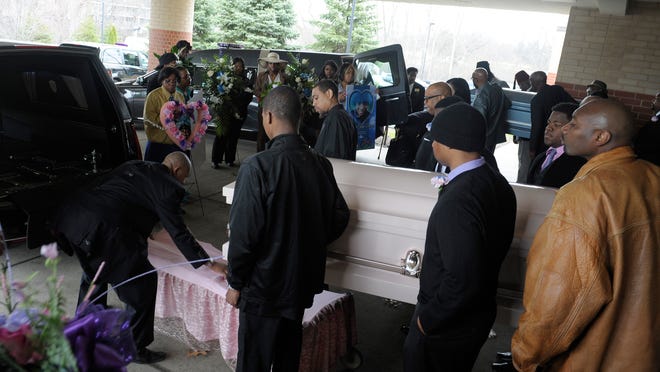 Pallbearers bring out the caskets of Stoni Ann Blair and Stephen Gage Berry after a funeral service Monday, April 13, 2015. The bodies of the two children were found inside a freezer of a Detroit apartment March 24.