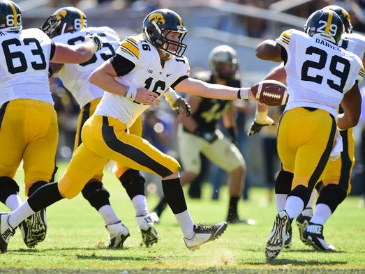 Sep 27, 2014; West Lafayette, IN, USA; Iowa Hawkeyes quarterback C.J. Beathard (16) hands off the ball to running back LeShun Daniels Jr. (29) during the second half of the game at Ross Ade Stadium. The Iowa Hawkeyes beat the Purdue Boilermakers 24 to 10. Mandatory Credit: Marc Lebryk-USA TODAY Sports