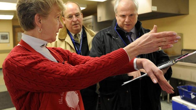 Carol Koepp gives directions to volunteer drivers for Meals On Wheels.