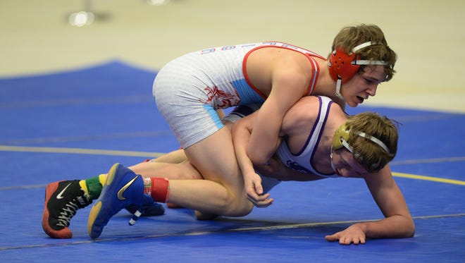 Bryce Sheffer of Union County takes down Male's Zane Brown in the 120 lb. weight class during the KHSAA State Wrestling Championships Wednesday, March 11, 2015.