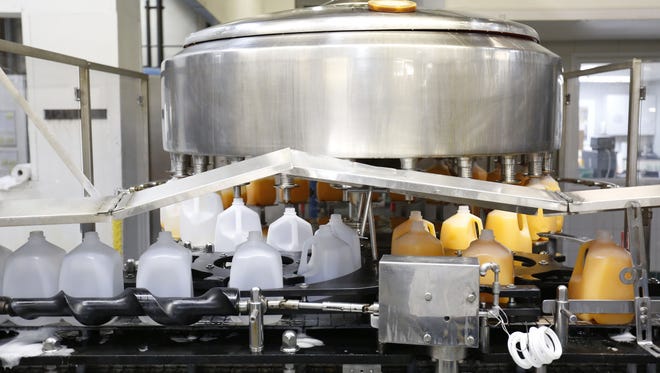 A juice product is bottled Wednesday afternoon at the Mrs. Clark's production plant in Ankeny.  The  company makes condiments and juices and plans to expand their plant.