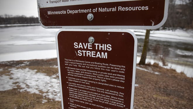 Signs highlight threats to water quality Wednesday, Jan. 25, at the confluence of the Sauk and Mississippi Rivers.