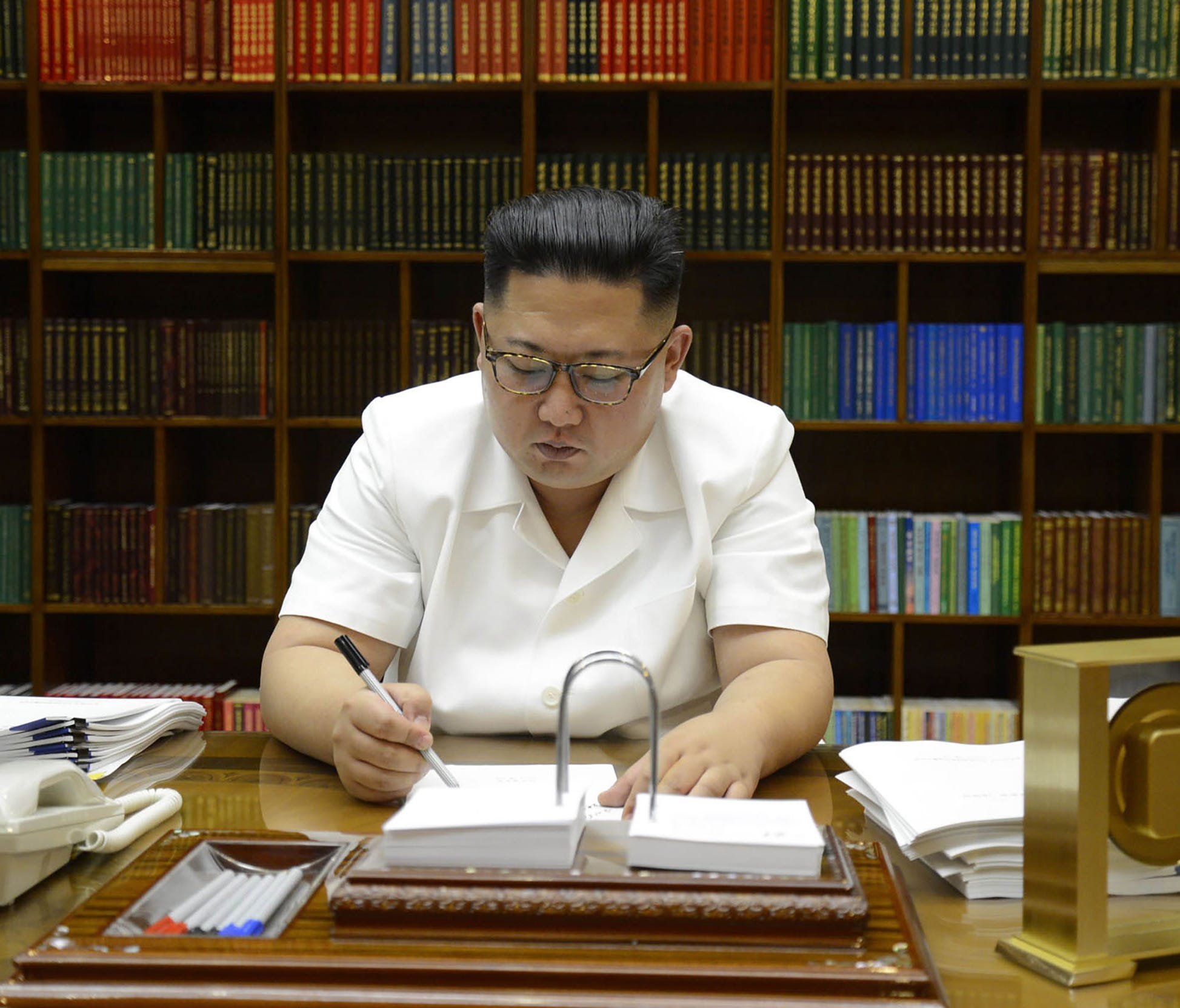 This July 27, 2017, photo released by North Korea's official Korean Central News Agency shows North Korean leader Kim Jong Un signing documents for the test launch of an intercontinental ballistic missile at an undisclosed place in his country.