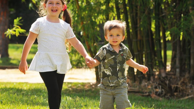 Glenda Rigby’s children, Sarah and Sonny, play on the grounds at the Healthy Start Coalition of Brevard office in Rockledge.