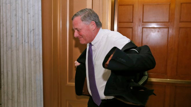Sen. Richard Burr, R-N.C., puts his jacket on as he heads to the Senate floor on Capitol Hill Tuesday in Washington.