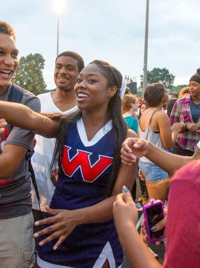 West high school students Jadarius Humphrey (left), Jazzmine Joiner (center) and Taylan Nelson (right) hang out during the Knoxville Orthopedic Clinic's Kickoff Classic at Knoxville West high school Friday,Aug. 14, 2015. 