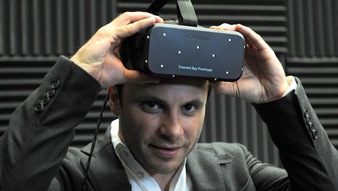 Oculus VR CEO Brendan Iribe shows off Oculus Rift.