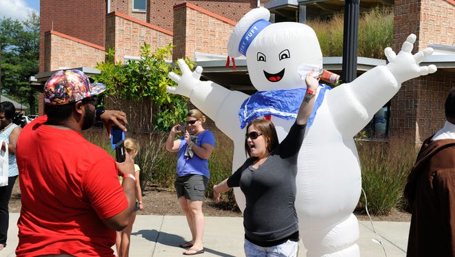 People pose for photos with the Stay Puft Marshmallow Man at the Dover Comic Con in Dover. Local chapters of the Ghostbusters will be at Amazicon this weekend, too.