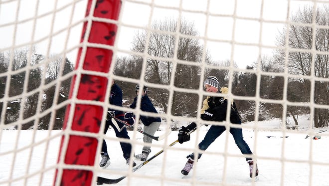 Sasha Shears, 15 of Dallastown, shoots for the net while playing ice hockey with friends on Lake Redman in William H. Kain County Park, Monday Feb. 16, 2016. John A. Pavoncello photo