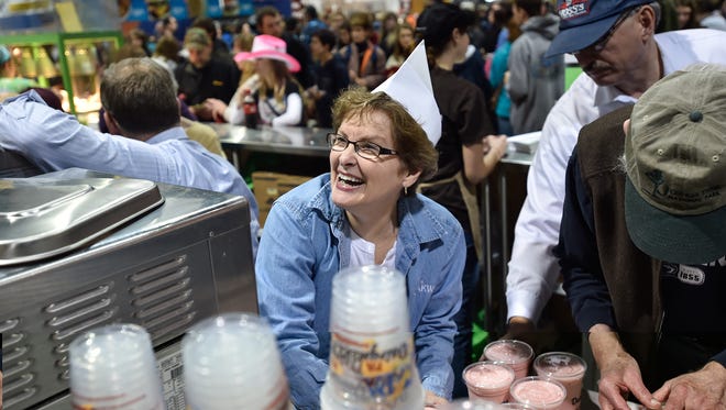 2016: Nancy Martin smiles as she makes shakes inside the Milk Shake stand at the 100th Pennsylvania Farm Show Saturday. Martin is a volunteer along with everyone working in the milkshake stall.