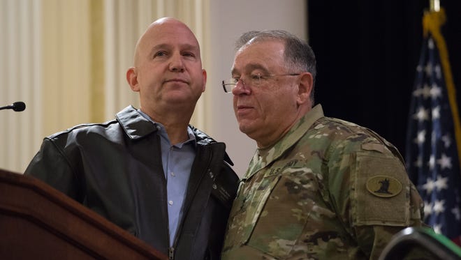 Governor Jack Markell, left, and Major General Francis D. Vavala, adjutant general for the Delaware National Guard, embrace one another at the 17th Annual Senior Leaders Conference at Dover Downs Hotel.