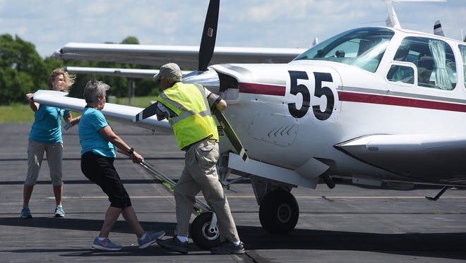 The Houston Hot Flashes team gets ready to leave Coshocton's Richard Downing Airport after a fuel stop during the Air Race Classic.