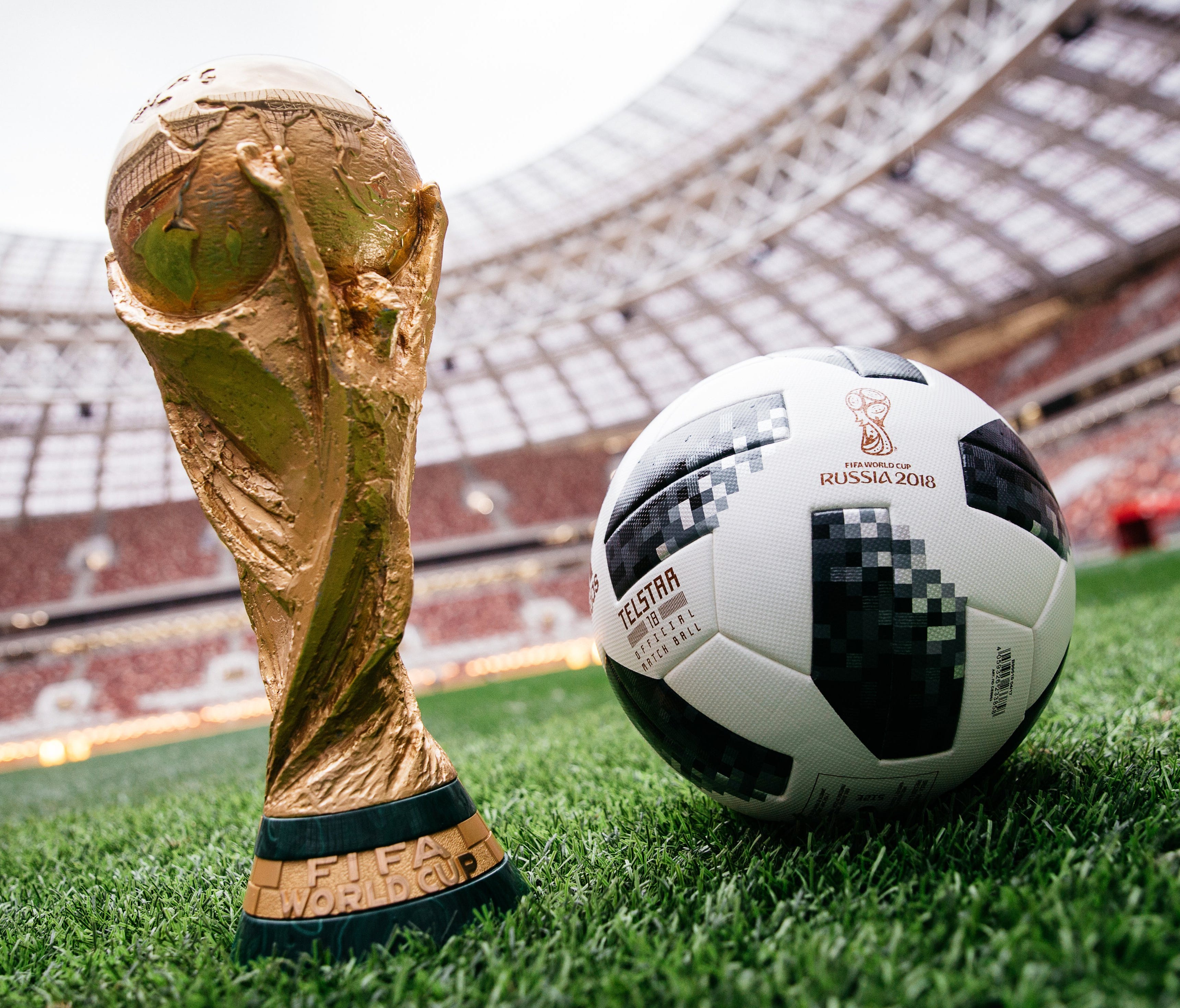 An adidas official match ball, named Telstar 18, sits next to the FIFA World Cup trophy in Luzhniki Stadium in Moscow.