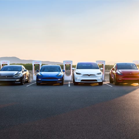 family of Tesla vehicles parked in front of superc