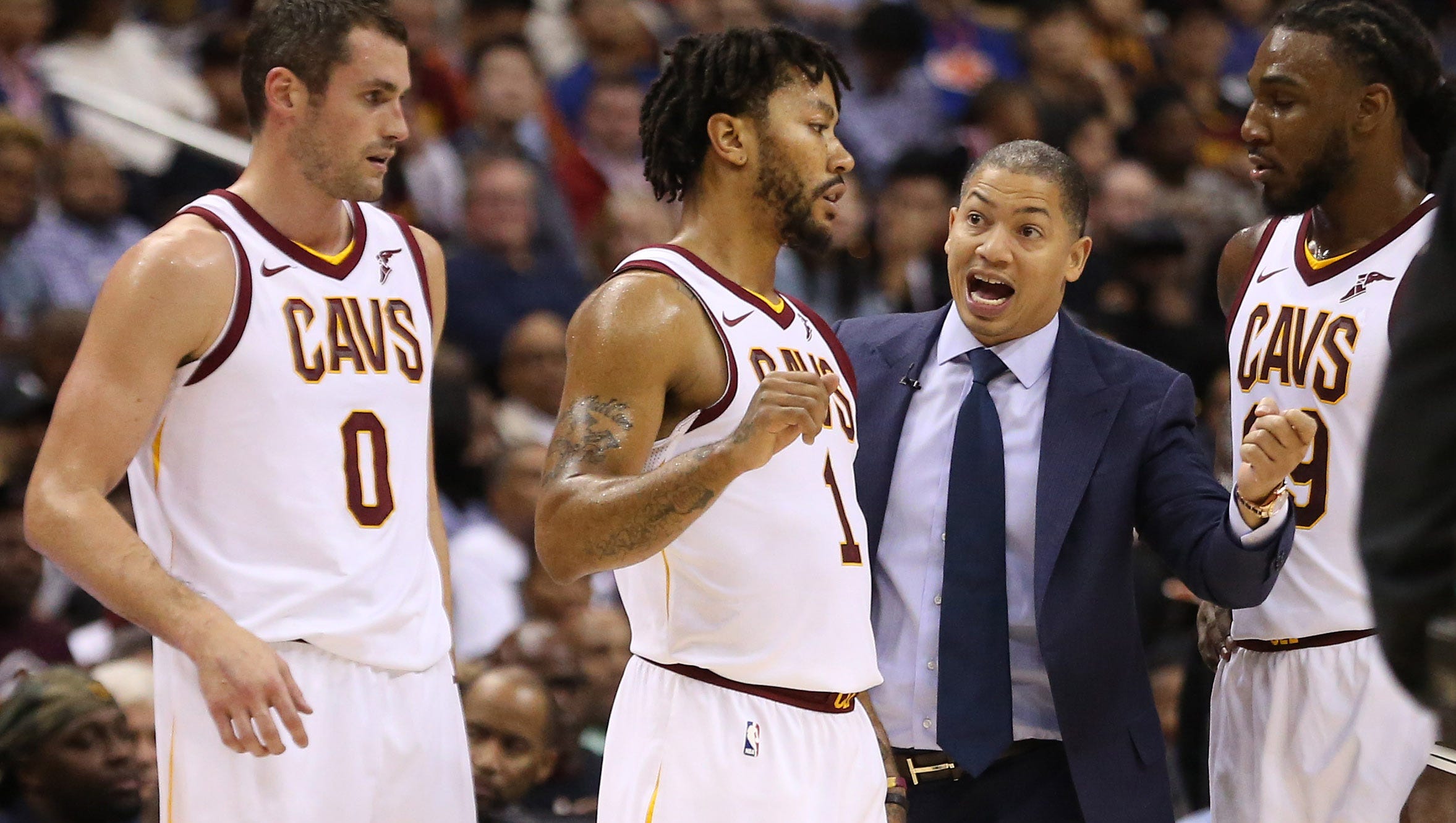 Cleveland Cavaliers head coach Tyronn Lue (M) talks with Cavaliers guard Derrick Rose (1), Cavaliers forward Kevin Love (0), and Cavaliers forward Jae Crowder (99) against the Washington Wizards at Capital One Arena.