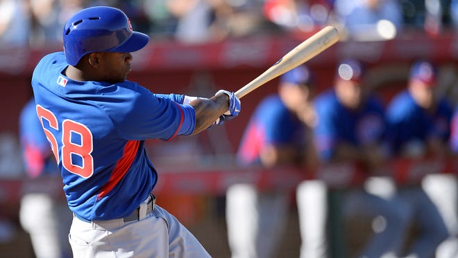 Mar 7, 2014; Tempe, AZ, USA; Chicago Cubs right fielder Jorge Soler (68) hits a triple to drive in the go ahead run in the ninth inning of a spring training game against the Los Angeles Angels at Tempe Diablo Stadium. The Cubs won 3-2.