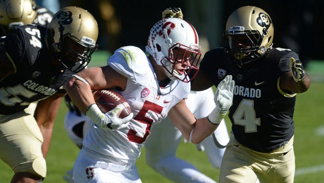 Colorado defensive back Chidobe Awuzie looks to tackle Stanford running back Christian McCaffrey (5) during a 2015 game.