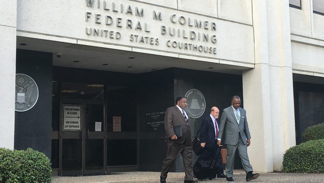 The Rev. Kenneth Fairley, left, is seen leaving William M. Colmer Federal Courthouse on Friday with attorneys Arnold Spencer, center, and Bertram Marks. Testimony is expected to resume Saturday.