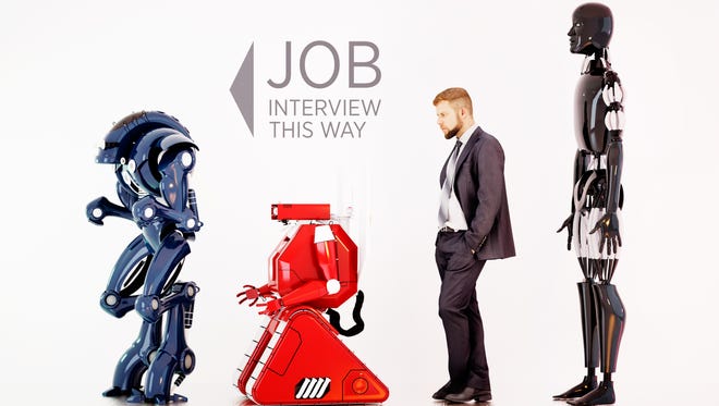 A man waiting in line between robots on a job interview.