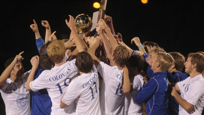 Covington Catholic players celebrate their first-ever state championship in boys’ soccer Saturday.