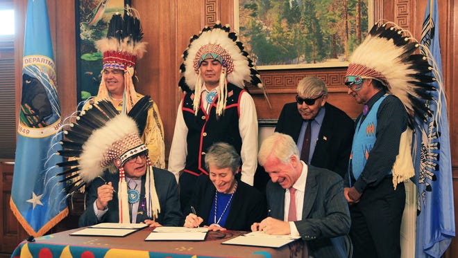 Blackfeet tribal members look on as Interior Secretary Sally Jewell signs the cancellation of 15 of the final 17 leases of undeveloped land in the Badger-Two Medicine last year in Washington, D.C. Interior Secretary Sally Jewell announced the cancellation of two more leases Tuesday.