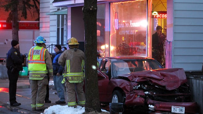 A car sits near the entrance to Taqueria Tres Hermanos on Wausau's east side after it was involved in a two-vehicle crash at the intersection of Fulton Street and N. 6th Street in Wausau at about 7:20 p.m., Sunday, March 29, 2015. A pickup driven by a 16-year-old female was cited for running the stop sign on Fulton St. at the intersection. The car was driven by a 70-year-old Wausau man. A 69-year-old woman and a 5-month-old child were passengers in the car. The woman is in the car in the photo and is waiting to be transported by an ambulance.