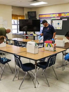 Austin district custodians deep clean Galindo Elementary School in March amid the coronavirus outbreak. The school district spent $7 million in the first six weeks after schools shuttered in coronavirus-related expenses like disinfecting building, protective equipment and purchasing technology for online learning.
