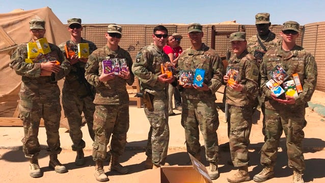 Soldiers with the 2-44 Air Defense Artillery from Fort Campbell with their newly delivered Girl Scout Cookies in Afghanistan.