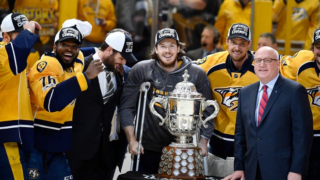 May 22, 2017; Nashville, TN, USA; Nashville Predators center Ryan Johansen (middle) poses with teammates and the Clarence S. Campbell Bowl trophy after a 6-3 win against the Anaheim Ducks in game six of the Western Conference Final of the 2017 Stanley Cup Playoffs at Bridgestone Arena. Mandatory Credit: Christopher Hanewinckel-USA TODAY Sports ORG XMIT: USATSI-359320 ORIG FILE ID:  20170522_gma_ah2_231.jpg