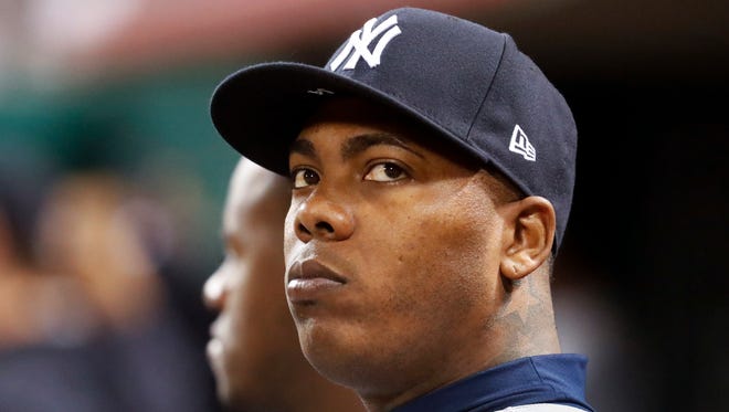 FILE - In this Monday, May 8, 2017, file photo, New York Yankees relief pitcher Aroldis Chapman sits in the dugout in the ninth inning of a baseball game against the Cincinnati Reds in Cincinnati. Chapman is getting his left shoulder (rotator cuff inflammation) looked at Friday and could start a throwing program as early as Saturday.