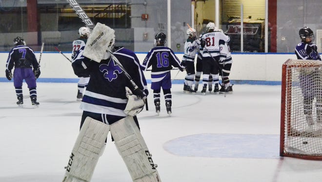 New Rochelle goalie Arthur Liebowitz reacts while Rivertown forward Alex Inglis celebrates a first-period goal with his linemates. The Legends moved on with a 4-1 win and will face Mamaroneck on Wednesday.