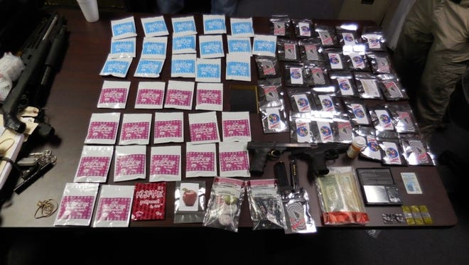 Some of the drugs and guns seized when a search warrant was served earlier this month is shown. Two Natchitoches residents are facing multiple charges for allegedly distributing synthetic marijuana.