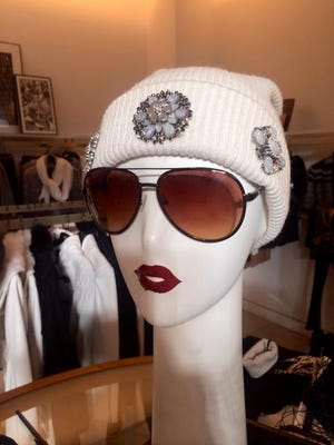 Look festive while staying warm with embellished winter wear. Knit hat with brooches, $88, BCBG Max Azria at The Mall at Green Hills, 2126 Abbott Martin Road, Nashville. www.bcbg.com; 615-292-0366