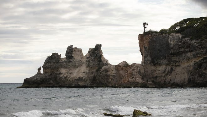 A natural formation known as "Punta Ventana," or Window Point, stands without the bridge that once created the formation of the window, or a hole, in Guayanilla, Puerto Rico, Monday, Jan. 6, 2020. The natural bridge collapsed during the morning's earthquake. (AP Photo/Jorge A. Ramirez Portela)