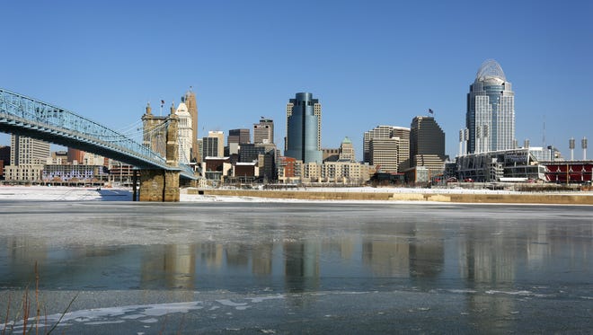 Downtown is reflected on ice floating on the Ohio River in below zero temperatures Thursday morning.