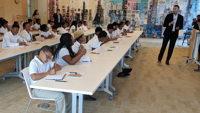 John Barker, managing director of the Kresge Foundation's investment office, teaches students about finances during the Money Matters for Youth summer camp at the foundation’s headquarters in Troy on Thursday, July 19, 2018.