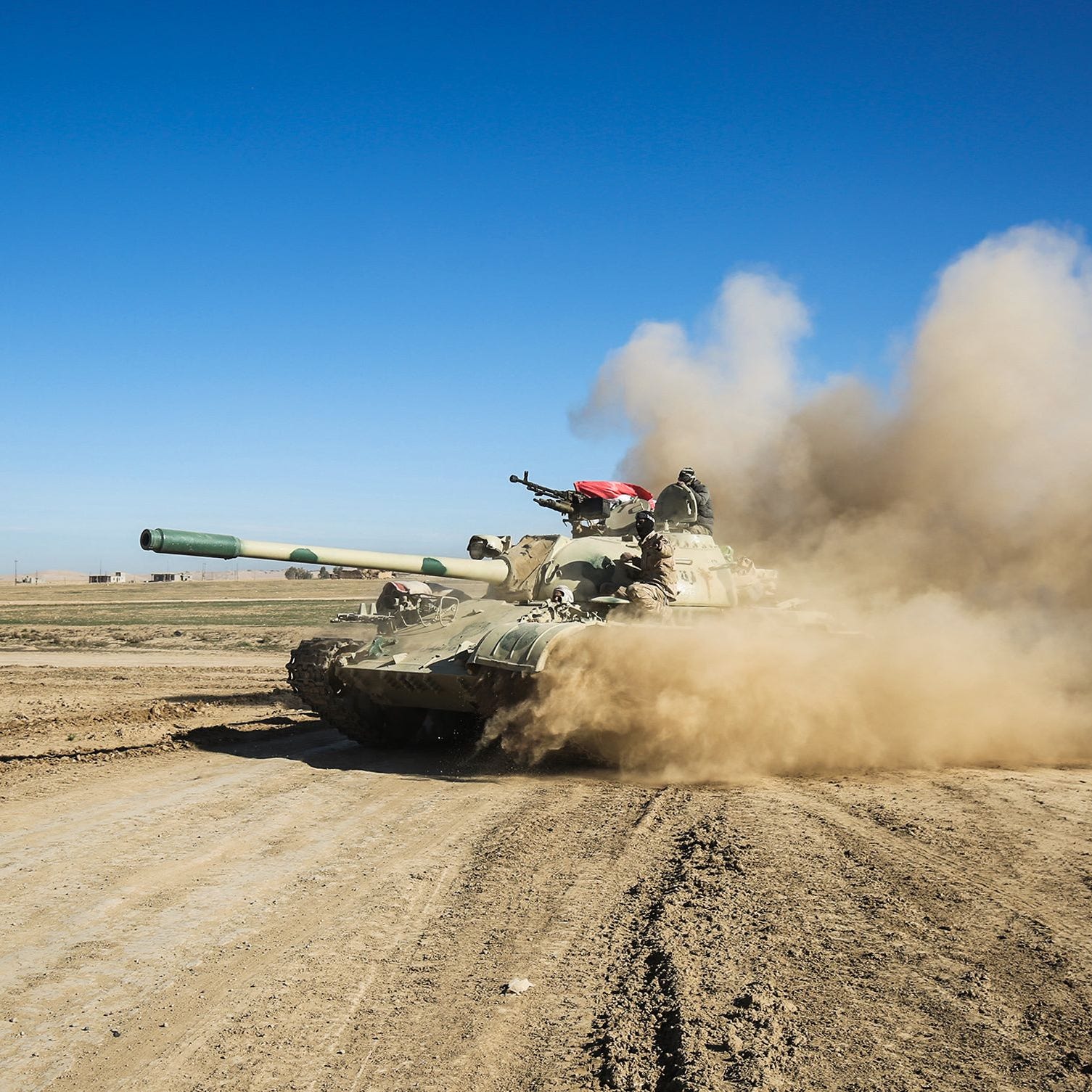 Tanks and armored vehicles of the Iraqi forces advance south of Mosul, Iraq. 