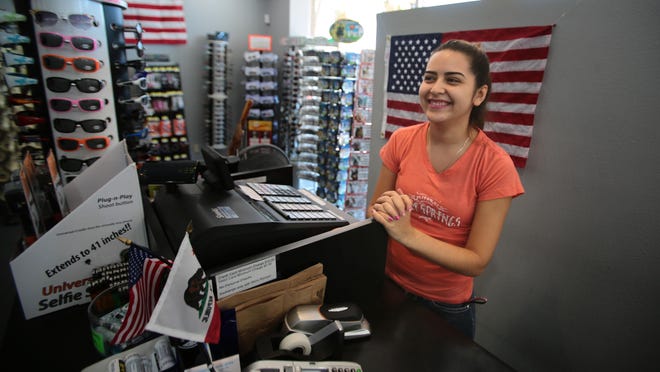 Edith Mercado, a cashier at the Palm Springs General Store in downtown Palm Springs, at her station on Labor Day. Members of California's State Board of Equalization will soon visit Palm Springs businesses to ensure they have the proper permits.