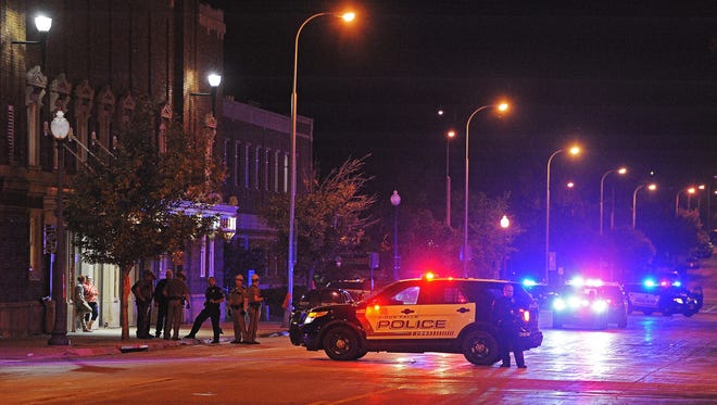 Law enforcement officers on scene early Saturday morning, Oct. 1, 2016, in the area near Main Avenue and 5th Street after being called because of people fighting and possible gunshots after a concert at the Multicultural Center in downtown Sioux Falls late Friday night. Police found no gunshot victims. 