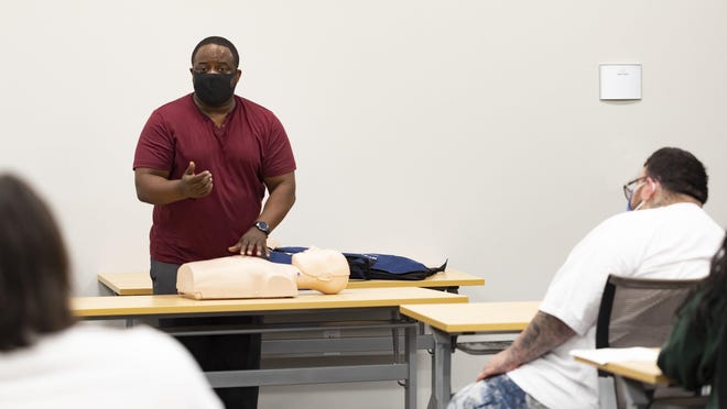 Todd Hamilton teaches a technique in class at Central Texas Allied Health Institute. The institute received a grant from St. David's Foundation to get more people of color trained in health fields.