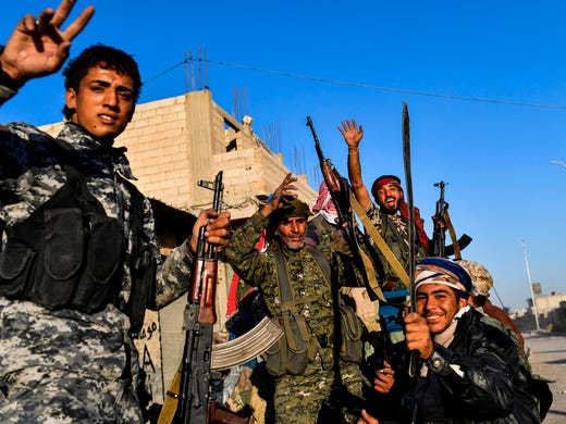 Members of the Syrian Democratic Forces celebrate