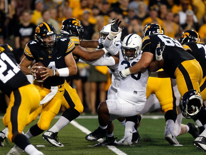 Iowa quarterback Nate Stanley scrambles out of the