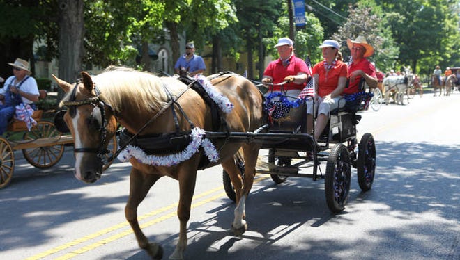 People ride in horse-drawn wagons during the Uncle Dave Macon Days Motorless Parade, This year's event steps off at 10 a.m. Saturday.