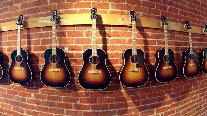 Gibson guitars built using original wood from folk singing legend Woody Guthrie's 1860s-era boyhood home are on display in the Gibson Brands Beverly Hills, Calif. showroom. Gibson plans to auction off the eight custom-made guitars on eBay beginning May 1 to raise money for a $600,000 rebuilding project of Guthrie's boyhood home in Okemah, Okla.