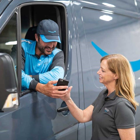An Amazon delivery driver speaking with a fellow e