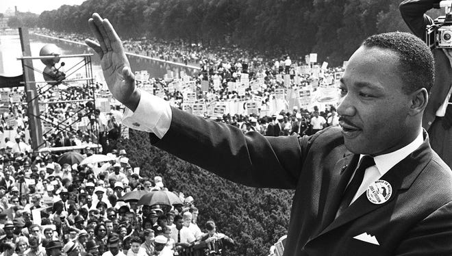 Martin Luther King,Jr. waves to supporters from the Lincoln Memorial on the Mall in Washington DC during the "March on Washington" in 1963.