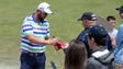 Marc Leishman signs autographs for fans as he walks