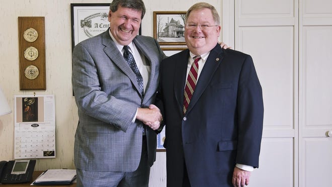 Craig Kempf and T.R. Shaw Jr. pose for a photo on Wednesday at Shaw Funeral Home in Battle Creek. Shaw sold his funeral homes in Battle Creek and Bellevue to Kempf.
