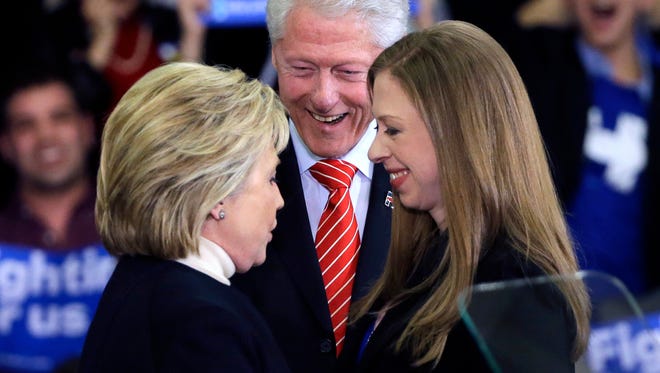 FILE - In this Feb. 9, 2016 file photo, Democratic presidential candidate Hillary Clinton huddles with her husband, former President Bill Clinton and daughter Chelsea at her New Hampshire presidential primary campaign rally in Hooksett, N.H.  (AP Photo/Elise Amendola, File)