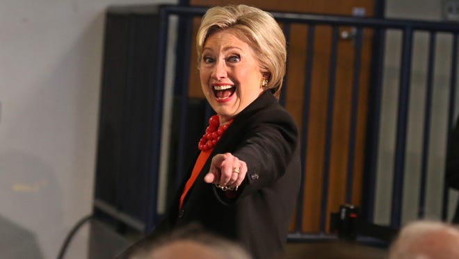 Hillary Clinton points to friendly faces she recognizes seated in the front row as she arrives at a manufacturing roundtable discussion at the Institute of Technology at Syracuse Central during her campaign swing through Syracuse Friday, April 1.  The roundtable was her first stop the day. 